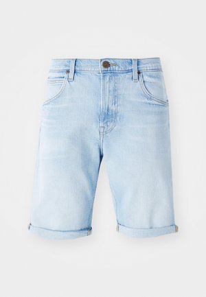Lichtblauwe denim shorts met opgerolde mouwen, klassiek vijf-pocket ontwerp en een bronzen logo patch op de tailleband. Gladde textuur.