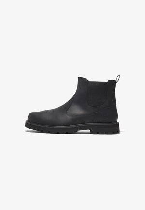 Bottine Chelsea en cuir noir avec panneaux latéraux élastiques, languette au talon et semelle en caoutchouc robuste. Logo Timberland embossé au talon.