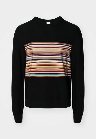 Black sweater with a round neckline, featuring a horizontal multicolored striped band across the chest in varying widths.