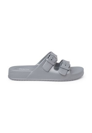 Gray slide sandal made of flexible material, featuring two adjustable buckles and a textured footbed for grip. Flat sole with ridged pattern.