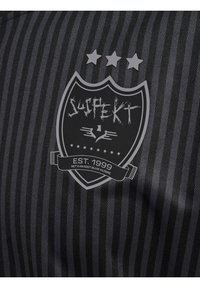 Sort stribet stof har et skjoldlogo med teksten "SUSPEKT," tre stjerner ovenfor, og "EST. 1999" i et banner nedenfor.