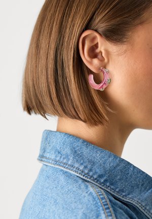 Pink acrylic hoop earring with light green acrylic accents, featuring a smooth surface and a semi-transparent design.