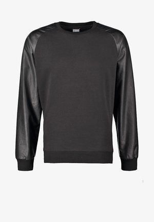 Zwarte sweatshirt met lange mouwen, gemaakt van gladde leren schouders. Het lijf is van een zachte stof en heeft een geribbelde zoom en manchet.
