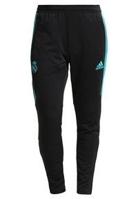 Schwarze Adidas-Trainingshose mit türkisfarbenen Streifen, Real Madrid-Logo auf dem linken Oberschenkel und Adidas-Logo auf dem rechten Oberschenkel.
