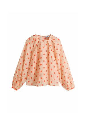 Bluza de culoarea piersicii cu mâneci lungi bufante și guler rotund, având un model cu buline portocalii pe toată suprafața.