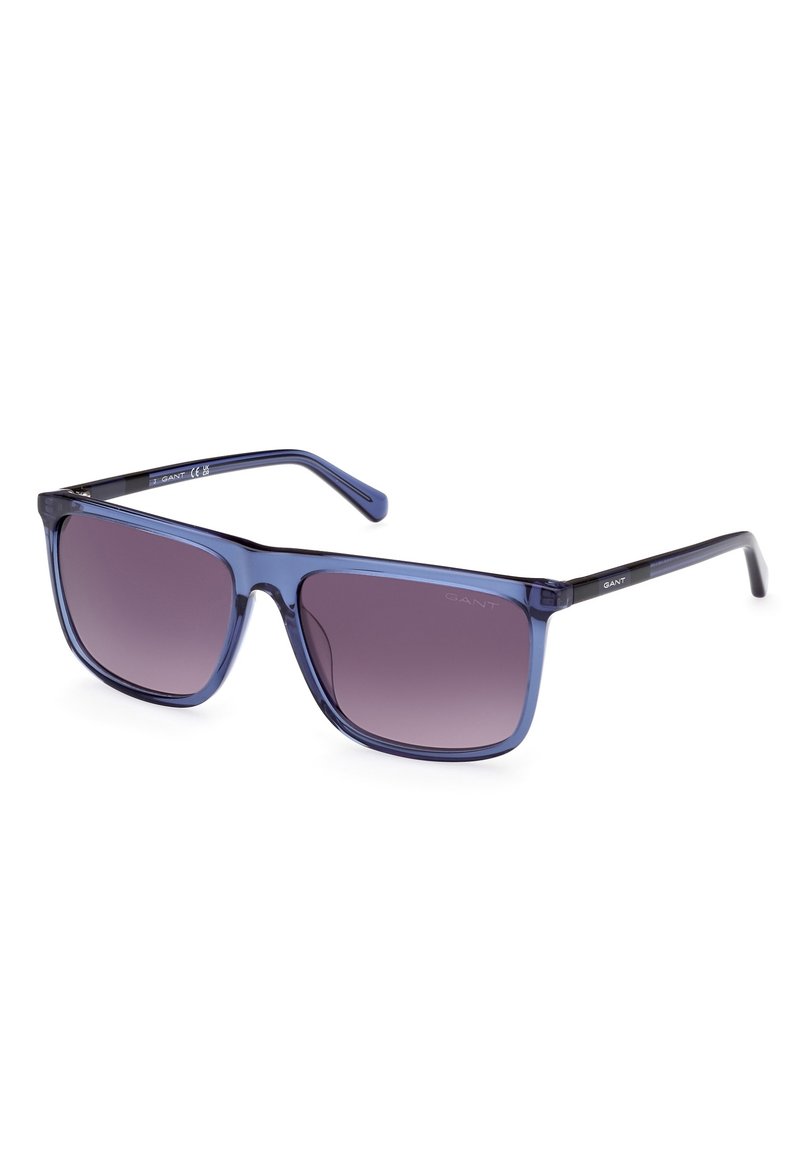 Gafas de sol con un marco azul transparente y lentes morados con degradado. Forma cuadrada con elegantes acentos negros en las patillas.