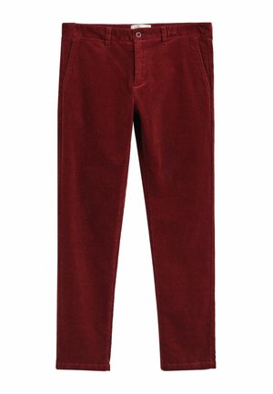 Pantaloni in corduroy color ruggine, slim fit, con passanti per cintura, tasche frontali e una singola tasca posteriore con chiusura a pulsante.