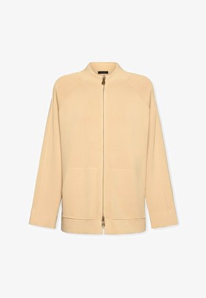 Giacca beige con cerniera e collo alto, dotata di tasche laterali, maniche lunghe e trama a coste. Design semplice senza motivi o decorazioni.