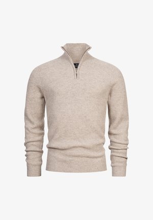 Pullover in maglia a costine beige con collo a mezza zip, maniche lunghe e orlo aderente. La texture appare morbida e calda.