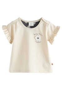 Hellbeiges kurzärmeliges Hemd mit gerüschten Kanten, rundem Ausschnitt und Blumenstickerei mit dem Schriftzug "daisy chain meadow".