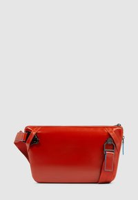 Borsa a tracolla in pelle rossa, forma rettangolare, con cerniera in metallo nero e dettaglio blu sulla tracolla. Texture liscia, design minimalista.