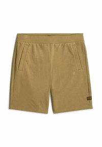 Shorts khaki fino al ginocchio realizzati in tessuto morbido; presentano due tasche laterali e un piccolo tag con il marchio sulla parte frontale. Tessuto liscio, vita elastica.