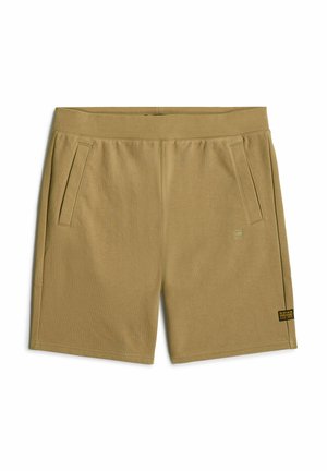 Shorts khaki fino al ginocchio realizzati in tessuto morbido; presentano due tasche laterali e un piccolo tag con il marchio sulla parte frontale. Tessuto liscio, vita elastica.