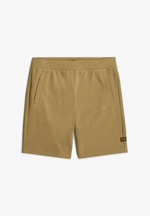 Shorts khaki fino al ginocchio realizzati in tessuto morbido; presentano due tasche laterali e un piccolo tag con il marchio sulla parte frontale. Tessuto liscio, vita elastica.