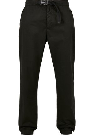 Pantalons noirs légers avec une taille élastique et un cordon de serrage. Jambes fuselées avec des poignets aux chevilles et une texture lisse.