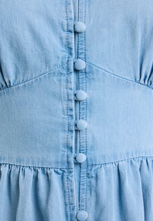 Világoskék farmerruha gombos zárással, hat anyaggal borított gombbal, ráncolt anyaggal a deréknál és texturált felülettel.