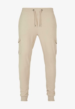 Beezid joggerid pehmest kangast, millel on elastne vöökoht koos nööridega, kaks cargo taskut ja soonikkoes sääreotsad.