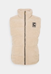Gilet en polaire beige avec un col montant, fermeture éclair à l'avant et logo KANI noir. Surface texturée avec un design rembourré, sans manches et coupe décontractée.