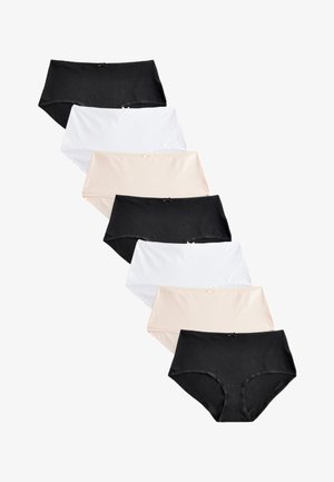 Seitse naiste puuvillased püksikud mustas, valges ja beežis värvitoonis, paigutatud valgele taustale nihutatult vertikaalsesse ritta.