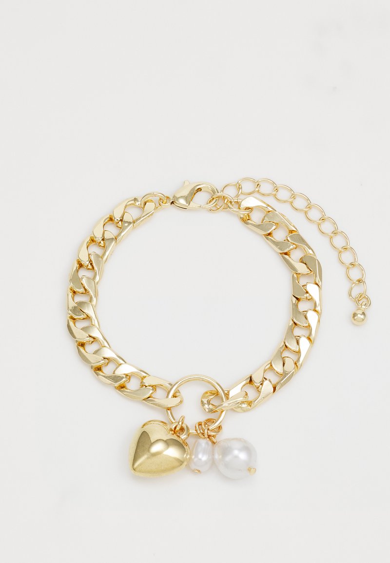 Gold chain bracelet featuring large links, a heart charm, and two pearl accents. Adjustable clasp with extension chain for size variation.