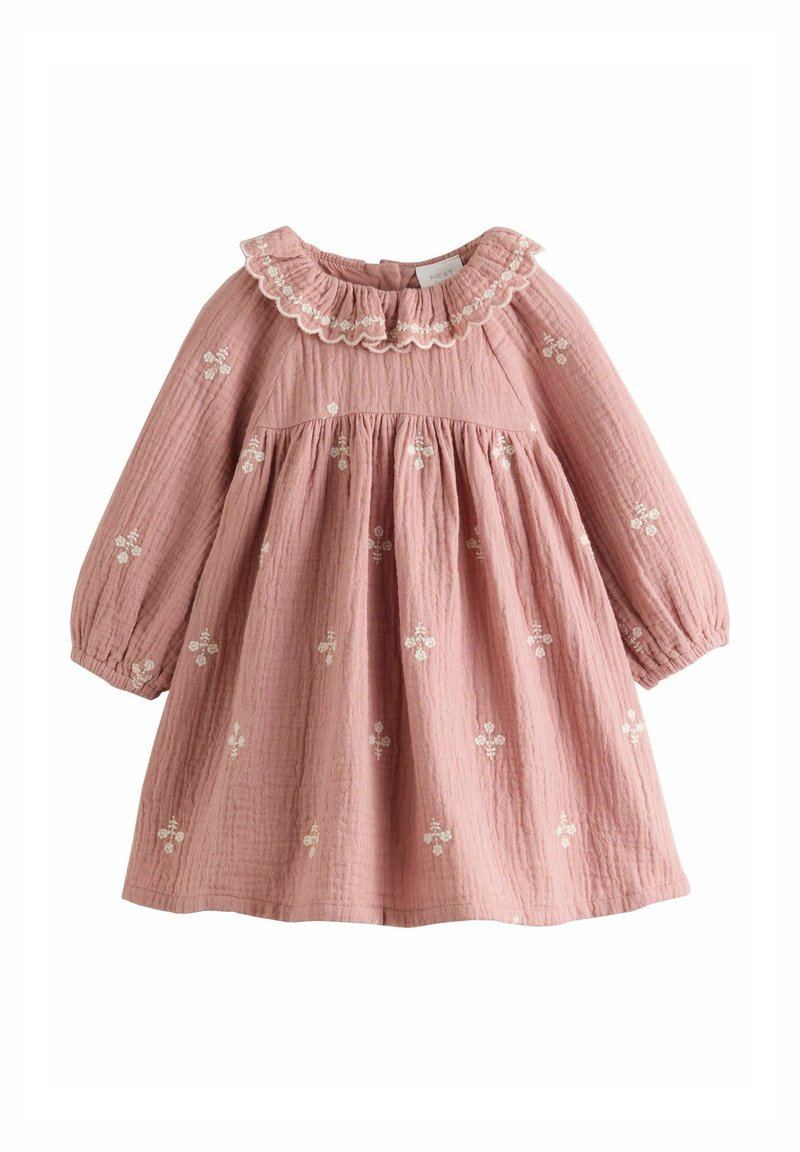 Pink cotton dress with long sleeves, ruffled collar, and floral embroidery. Textured fabric with gathered bodice and flared skirt.