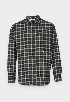 Black and white plaid button-up shirt with long sleeves, featuring a collar and a small logo detail on the left chest. Textured fabric.