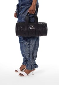 Gepofte zwarte leren handtas met dubbele handvatten, voorzien van een zilveren logo. De tas heeft een cilindervorm en een strakke afwerking.