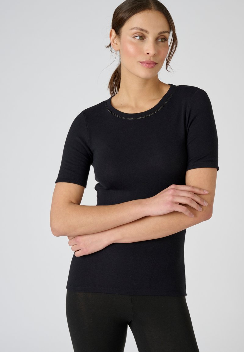 Black fitted t-shirt with short sleeves, round neckline, and subtle contrast stitching. Smooth texture with a snug fit.