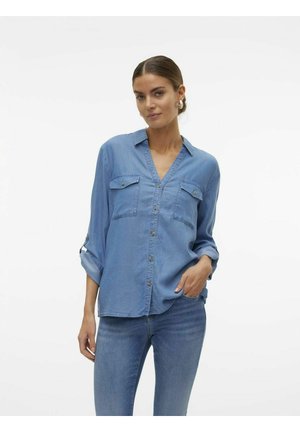 Helesinise denim särk pikkade varrukatega, nupu kaudu sulgemine, kahe rinnataskuga ja rullitud varrukatega. Pehme tekstuur ja lõdva istuvusega.