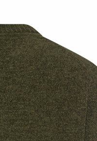 Dark green tweed fabric with a textured weave and a visible seam on a tailored garment shoulder.
