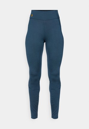 Mellomhøyde, tettsittende leggings i et mørkeblått stoff. Har en flat linning og sømdetaljer langs beina. Myk tekstur, egnet for treningstøy.