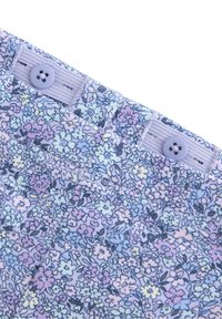 Lätt tyg med blommönster i pastellfärger (lavendel, blå, gul). Har ett midjeband med två lavendelfärgade knappar.