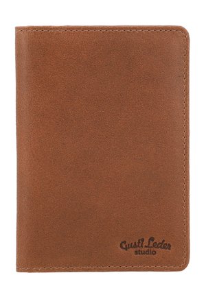 Brown leather wallet with visible stitching and a small embossed logo reading "Gusti Leder studio" in the bottom right corner.