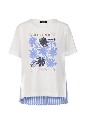 White short-sleeve T-shirt with blue palm leaf print, gold text "Saint-Tropez" and "Cote D'Azur," and blue-white striped back hem.