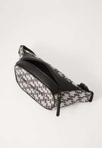 Textured black and grey fanny pack features zigzag pattern, front zippered compartment, and adjustable strap for secure wear.