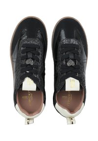 Sneaker neri con una parte superiore in pelle testurizzata, sezioni nere lisce, suole in gomma e lacci neri. Dettaglio a forma di cuore sulla linguetta.