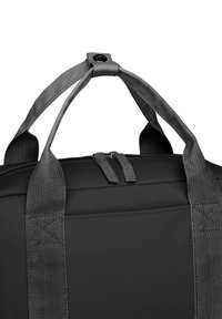 Black duffel bag with grey textured handles, zippered closure, and reinforced stitching for durability. Compact and functional design.