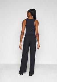 Under Armour MOTION OPEN PANT - Treningo apatinė dalis - black/white