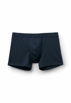 Pánské boxerky tmavě modré barvy s malými bílými puntíky, elastickým pasem a předním tvarovaným pytlíkem, zobrazené na bílém pozadí.