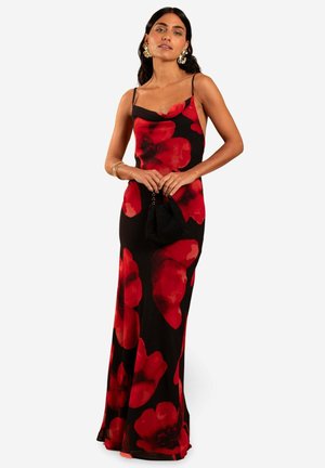 Black floral maxi dress featuring large red abstract patterns, thin spaghetti straps, and a flowy fit. Complemented by a small black clutch.