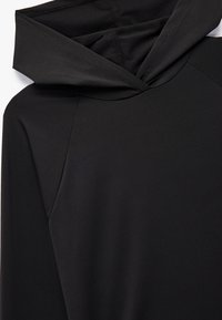 Zwarte hoodie met een soepele textuur, voorzien van een opgevouwen capuchon, raglanmouwen en minimale naden voor een gestroomlijnd ontwerp.