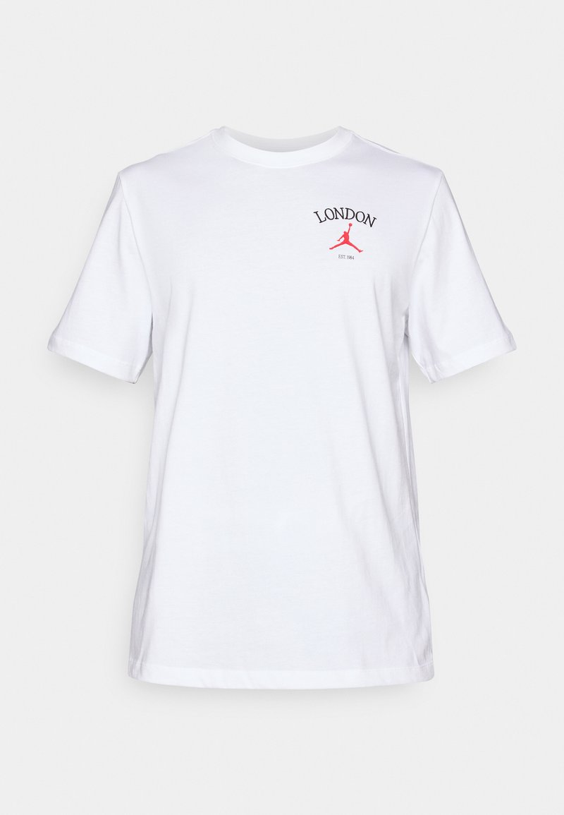 T-shirt en coton blanc à manches courtes, arborant le texte rouge "LONDON" et un logo Jordan rouge, col rond classique.
