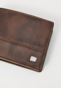 Brown leather wallet with a textured surface, featuring a silver logo accent and contrasting stitching along the edges. Compact design.