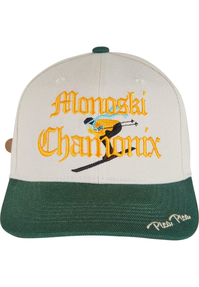 Căciulă cu coroana bej și vizieră verde. Prezintă brodat "Monoski Chamonix" în portocalie și albastră, împreună cu un grafic cu schior. Material texturat.