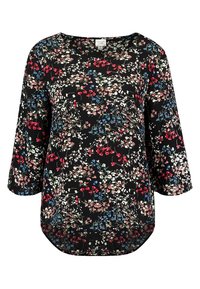 Långärmad svart topp med en färgglad blommönster med röda, blå och vita blommor, rundad nederkant och rund halsringning.