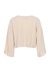 Lichtbeige cropped top met brede, vloeiende mouwen. De stof lijkt zacht en lichtgewicht, met een open rugdesign.