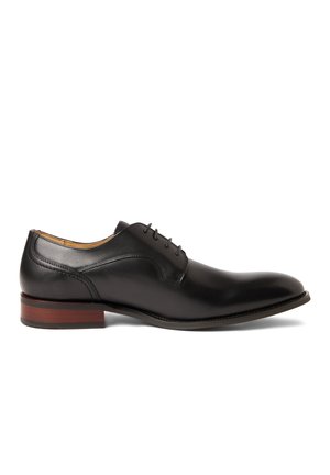 Black leather men's dress shoe with closed lacing, featuring a brown stacked heel and smooth polished finish, shown in side profile.