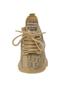 Baskets de sport beiges avec un dessus en tissu texturé, des lacets à l'avant et un écusson en logo transparent. Semelle en caoutchouc avec une finition lisse.