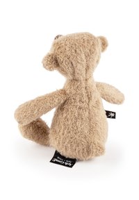 Light brown plush teddy bear with curly fur, short limbs, and round ears. Features a black tag with brand details at the base.