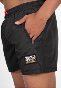 Wrong Friends LUGO - Shorts - black